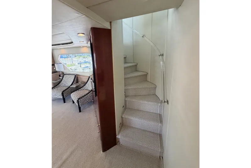 Slide: The Image of Interior of 1996 Hatteras yacht with elegant staircase and patterned chairs. - 22