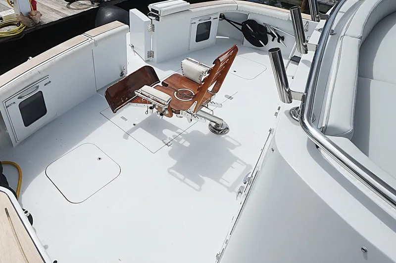 Slide: The Image of 1996 Hatteras boat deck with fishing chair and rod holders. - 34