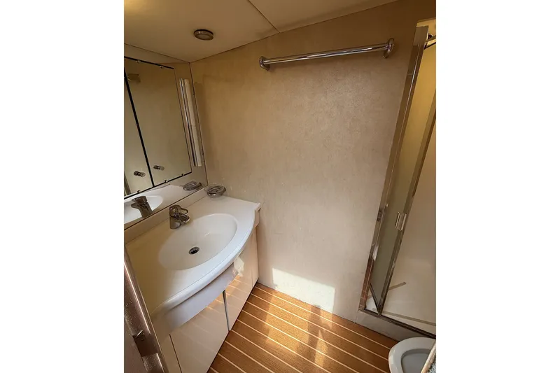 Slide: The Image of Bathroom interior of a 1996 Hatteras yacht with sink, mirror, and shower. - 20