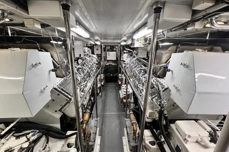 Slide: The Image of Engine room of a 1996 Hatteras yacht, featuring dual engines and complex machinery. - 41
