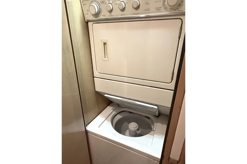 Slide: The Image of 1996 Hatteras stacked washer and dryer unit in a compact laundry space. - 21