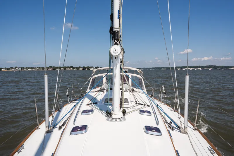 Slide: The Image of Sailing on a 2013 Sabre 456 yacht, clear skies, calm waters, scenic shoreline. - 37