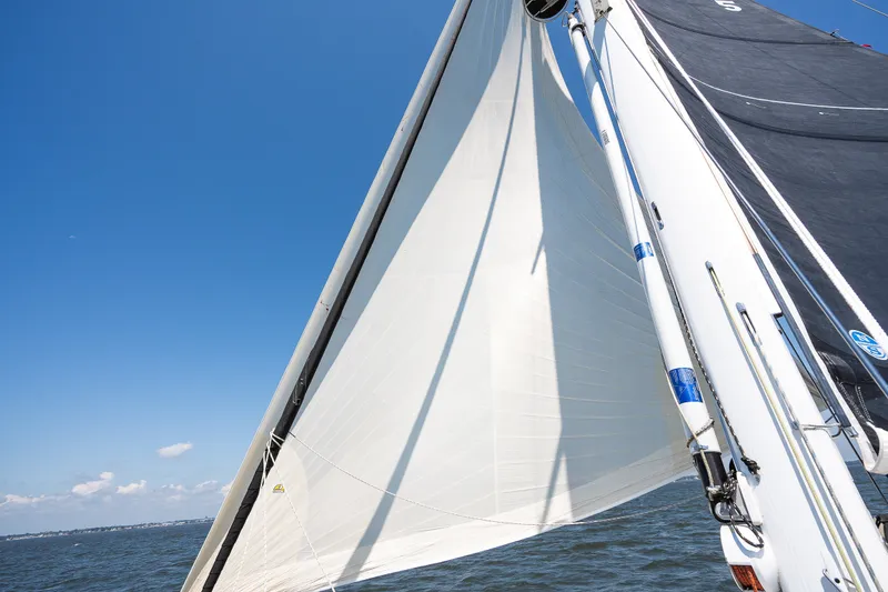 Slide: The Image of Sailing on a Sabre 456 yacht, 2013 model, with white sails against a clear blue sky. - 43