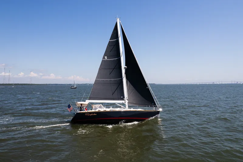 Slide: The Image of Sailing yacht Sabre 456 (2013) cruising on open water under clear blue skies. - 53