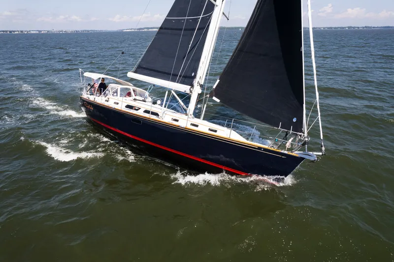 Slide: The Image of Sailing yacht Sabre 456 (2013) gliding on open water with black sails. - 48
