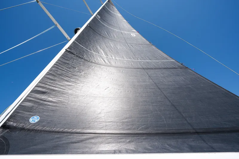 Slide: The Image of Sail of a 2013 Sabre 456 yacht against a clear blue sky. - 42