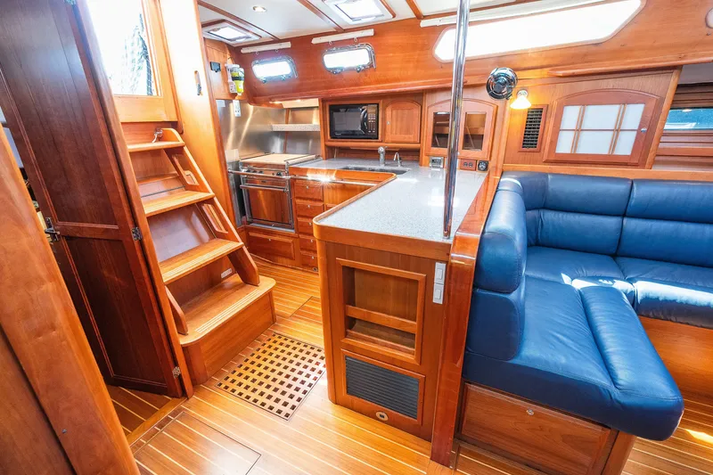 Slide: The Image of Luxurious interior of 2013 Sabre 456 yacht with wooden finishes and blue seating. - 8