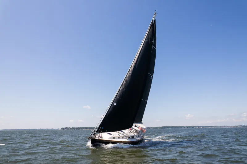 Slide: The Image of Sailing yacht Sabre 456 (2013) gliding on open water under clear blue skies. - 46