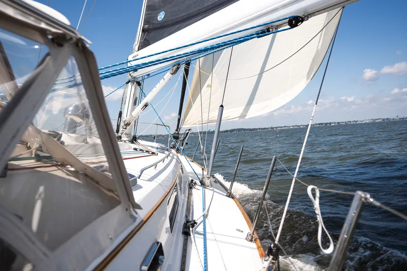 Slide: The Image of Sailing on a 2013 Sabre 456 yacht, gliding through open waters under clear skies. - 41