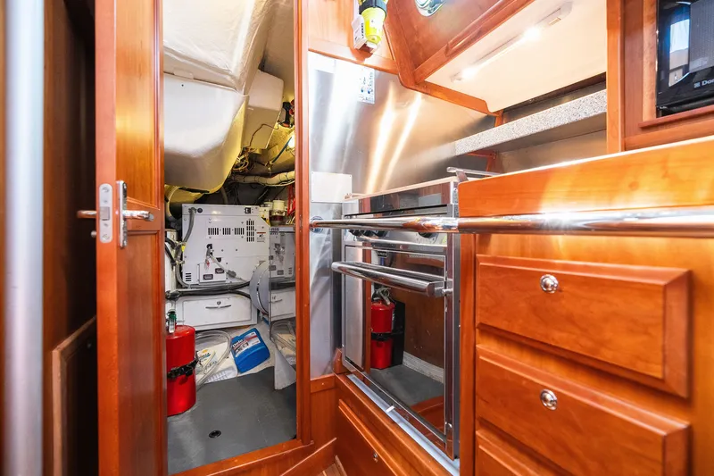 Slide: The Image of Engine room of 2013 Sabre 456 yacht with wooden cabinetry and stainless steel appliances. - 25