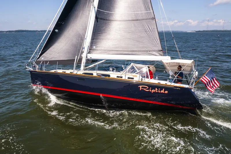 Slide: The Image of Sailing yacht "Riptide" on open water, Sabre 456 model, 2013, with American flag. - 34