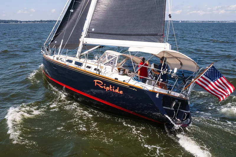 Slide: The Image of Sailing yacht "Riptide" on water, Sabre 456 model, 2013, with American flag. - 49