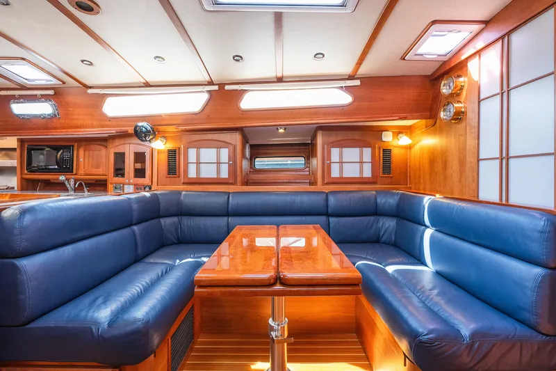 Slide: The Image of Luxurious Sabre 456 yacht interior with blue leather seating and wooden accents, 2013 model. - 12