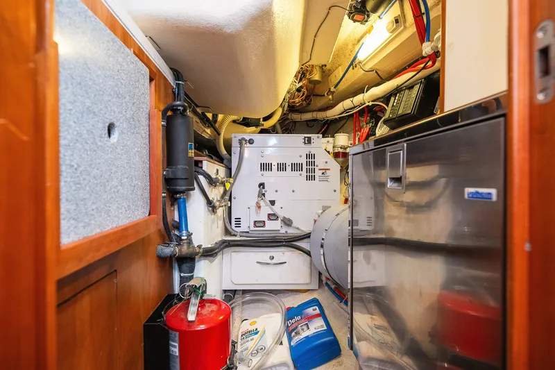 Slide: The Image of Engine room of a 2013 Sabre 456 yacht, featuring equipment and storage. - 26