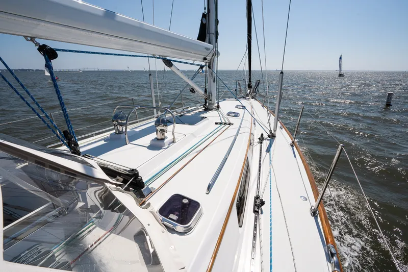 Slide: The Image of Sailing on a 2013 Sabre 456 yacht, gliding through calm waters under a clear blue sky. - 60
