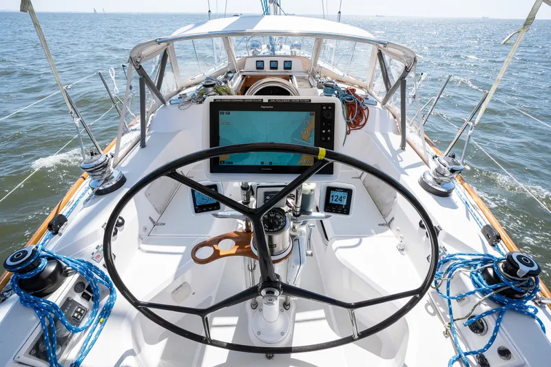 Slide: The Image of Cockpit of 2013 Sabre 456 sailboat with navigation equipment and steering wheel on open water. - 56