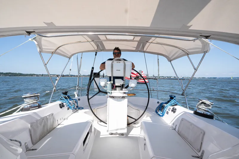 Slide: The Image of Man steering 2013 Sabre 456 sailboat on open water under clear sky. - 57