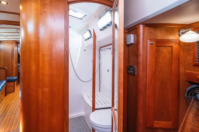 Slide: The Image of Luxurious 2013 Sabre 456 yacht interior with wooden cabinetry and modern bathroom amenities. - 19