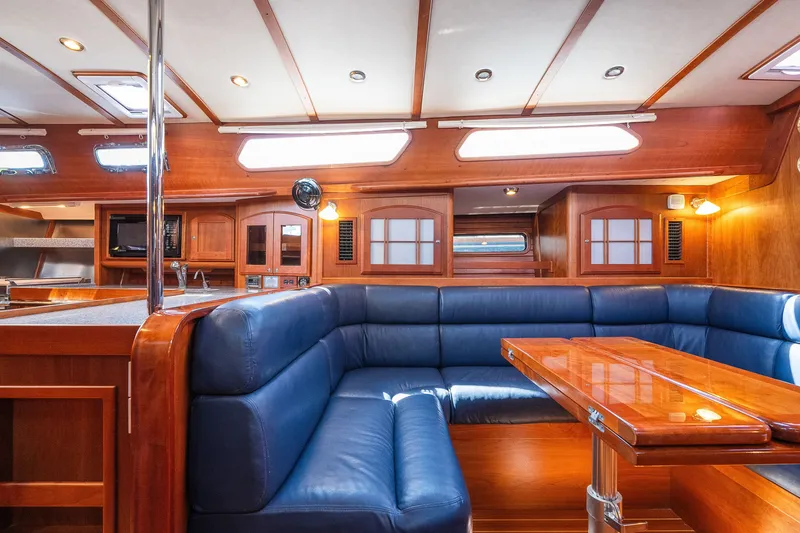 Slide: The Image of Luxurious interior of 2013 Sabre 456 yacht with blue seating and wooden finishes. - 11