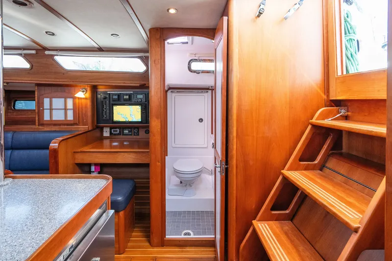 Slide: The Image of Interior of 2013 Sabre 456 yacht featuring navigation station and compact bathroom. - 22