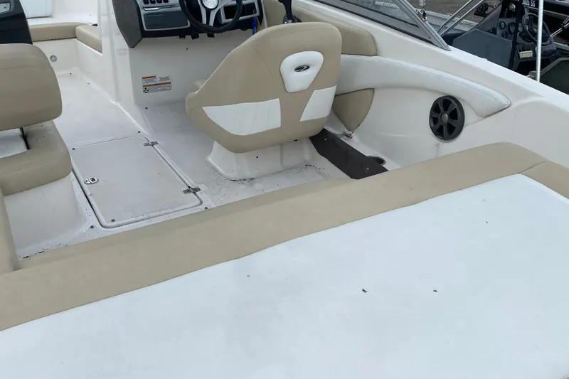 Slide: The Image of 2017 Regal 1900 ES Bowrider interior with beige seating and steering console. - 7
