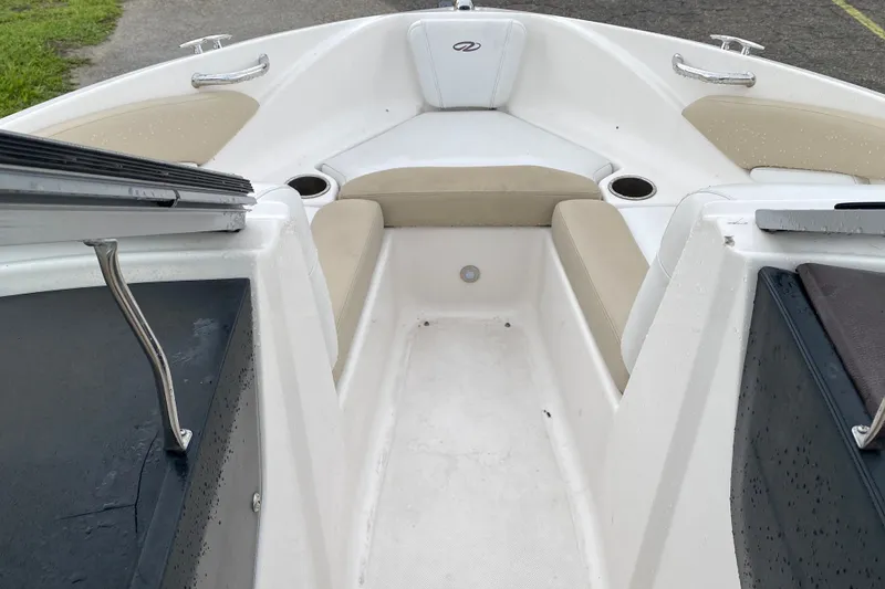 Slide: The Image of 2017 Regal 1900 ES Bowrider interior with beige seating and cup holders. - 9