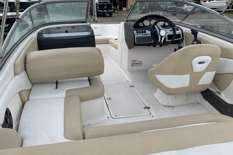 Slide: The Image of 2017 Regal 1900 ES Bowrider interior with beige seating and steering console. - 6