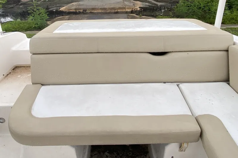 Slide: The Image of 2017 Regal 1900 ES Bowrider boat seating with beige cushions and white accents. - 12