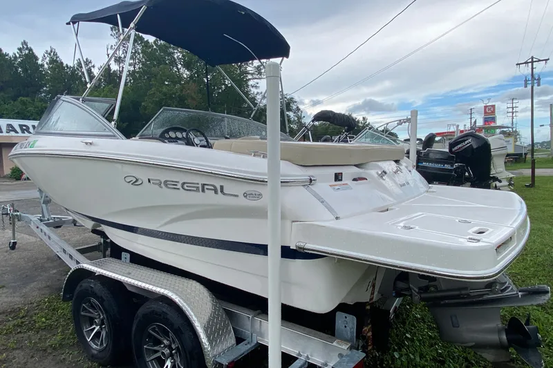 Slide: The Image of 2017 Regal 1900 ES Bowrider on trailer with canopy, parked outdoors. - 3