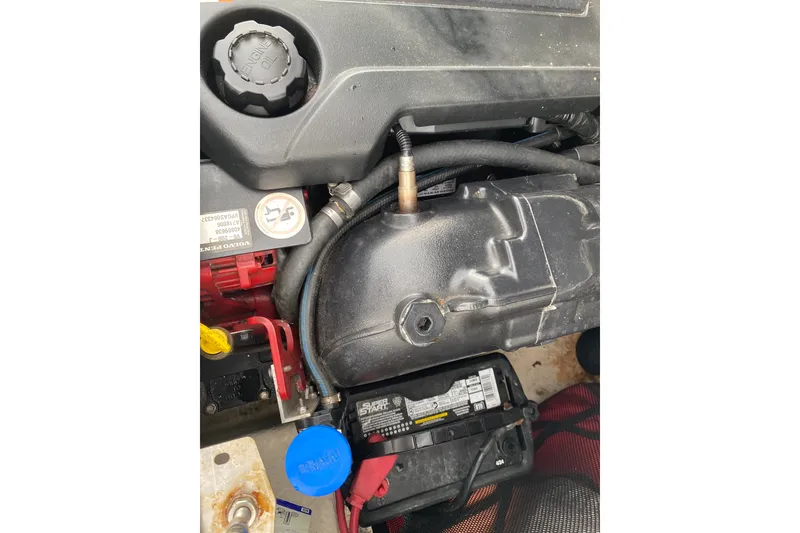 Slide: The Image of Engine compartment of a 2017 Regal 1900 ES Bowrider with visible battery and oil cap. - 14