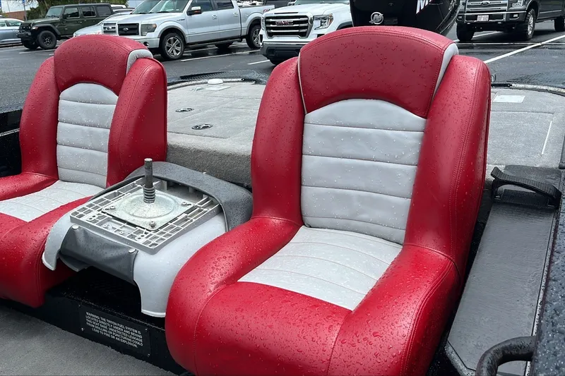 Slide: The Image of Red and gray seats on a 2008 Triton Tr-196 SC boat, wet from rain. - 2