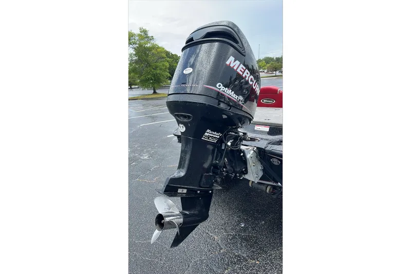 Slide: The Image of 2008 Triton Tr-196 SC boat with Mercury OptiMax outboard motor in parking lot. - 4