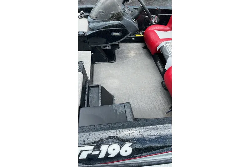 Slide: The Image of 2008 Triton Tr-196 SC boat interior with red seats and steering console. - 3