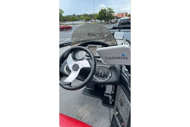Slide: The Image of 2008 Triton Tr-196 SC boat dashboard with Garmin GPS, wet from rain. - 5