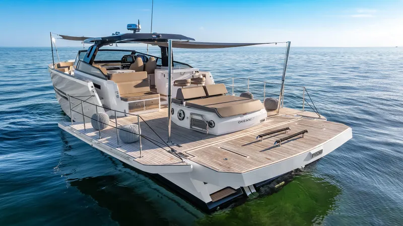 Slide: The Image of 2026 OKEAN 57 yacht cruising on calm ocean waters, featuring spacious deck and modern design. - 21
