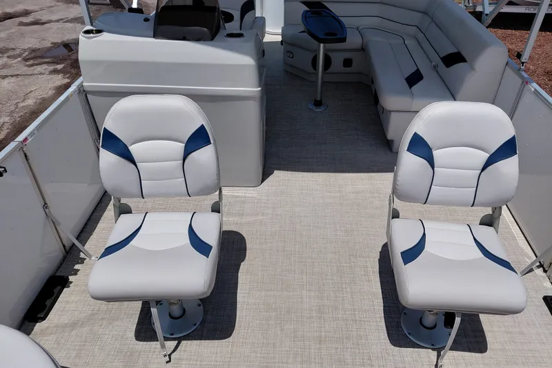 Slide: The Image of 2022 SunCatcher Select 20F boat interior with white and blue seating arrangement. - 14