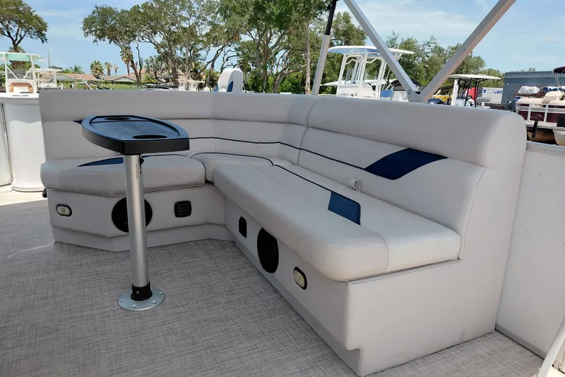 Slide: The Image of Luxurious seating area on a 2022 SunCatcher Select 20F boat, featuring a sleek design and table. - 25
