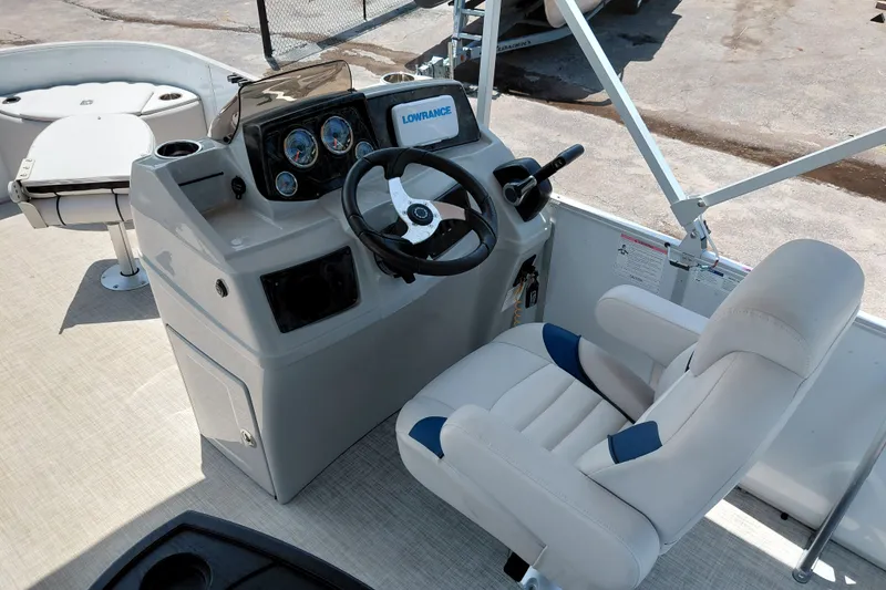Slide: The Image of 2022 SunCatcher Select 20F boat helm with steering wheel and comfortable captain's chair. - 21