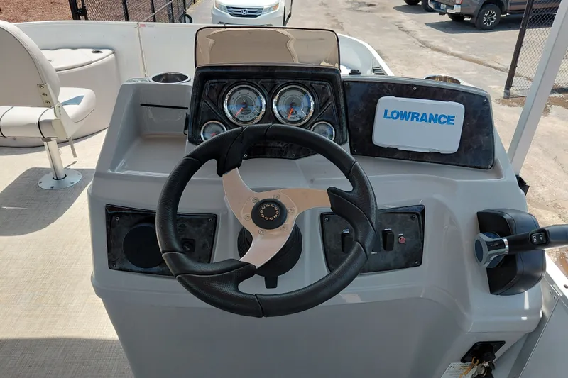 Slide: The Image of 2022 SunCatcher Select 20F boat dashboard with steering wheel and Lowrance navigation system. - 35
