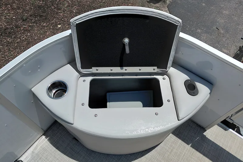 Slide: The Image of 2022 SunCatcher Select 20F boat storage compartment with cup holder and open lid. - 17