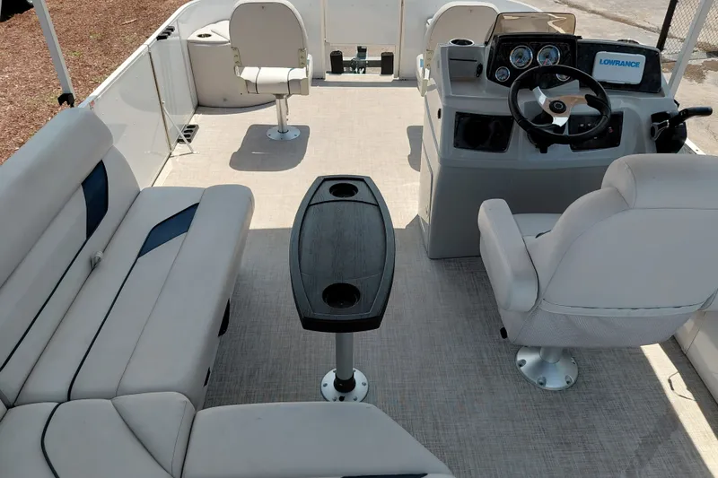 Slide: The Image of 2022 SunCatcher Select 20F pontoon boat interior with seating and steering console. - 34