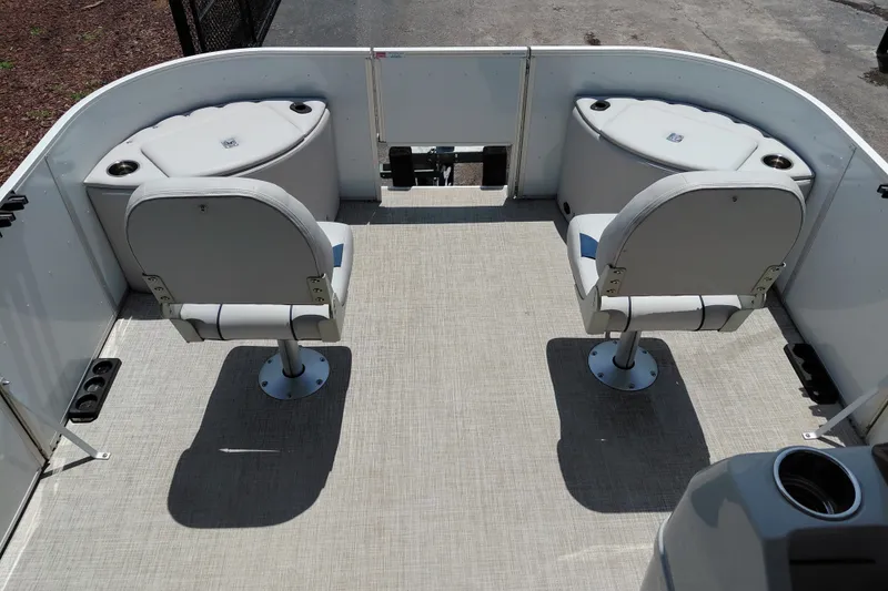 Slide: The Image of 2022 SunCatcher Select 20F boat interior with two swivel seats and storage compartments. - 15