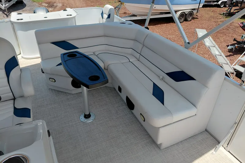 Slide: The Image of Luxurious seating area on 2022 SunCatcher Select 20F pontoon boat with table and cup holders. - 20