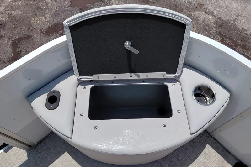 Slide: The Image of SunCatcher Select 20F 2022 boat storage compartment with cup holder and open lid. - 18