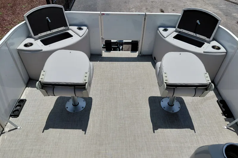 Slide: The Image of 2022 SunCatcher Select 20F boat interior with two swivel seats and storage compartments. - 16