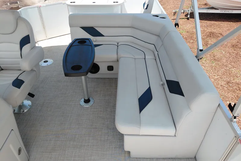 Slide: The Image of Interior of 2022 SunCatcher Select 20F pontoon boat with plush seating and table. - 23