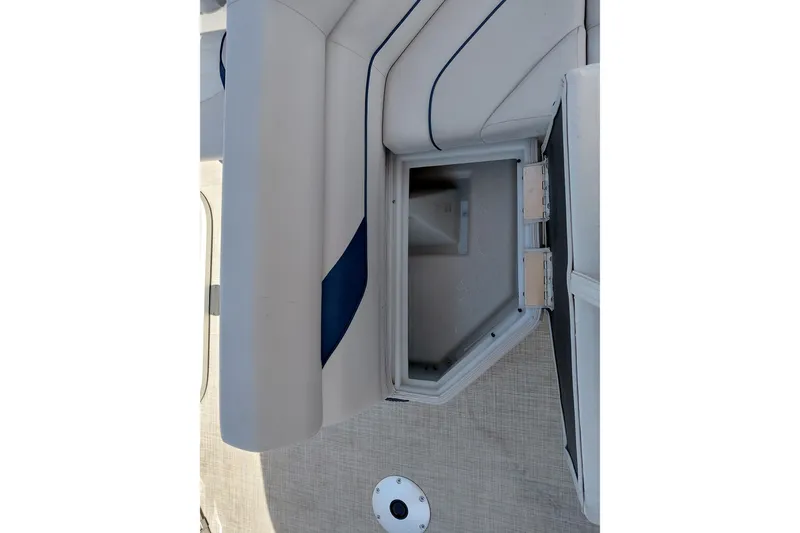 Slide: The Image of Open storage compartment on 2022 SunCatcher Select 20F boat with cushioned seating. - 27
