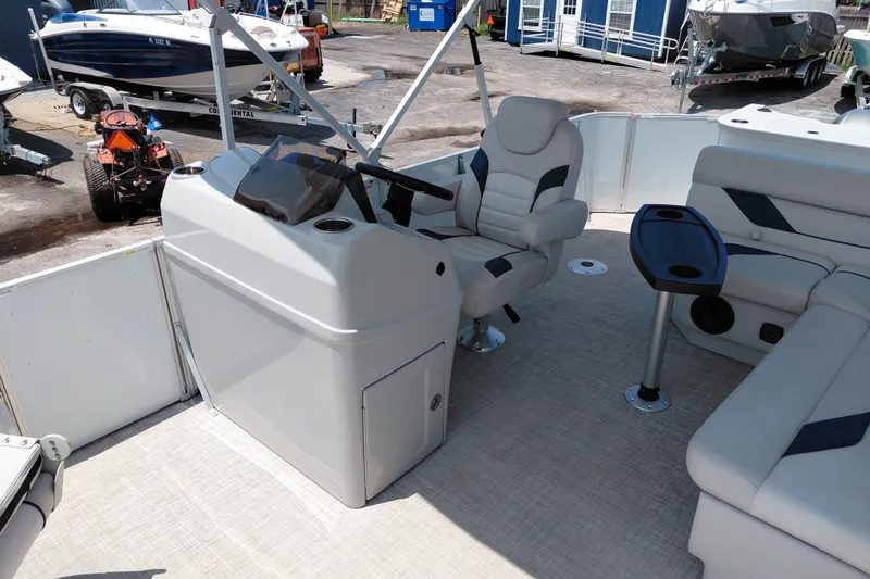 Slide: The Image of 2022 SunCatcher Select 20F pontoon boat interior with helm, seating, and table. - 19