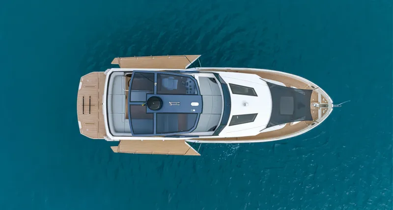 Slide: The Image of Aerial view of 2025 OKEAN 52 yacht on blue water. - 32
