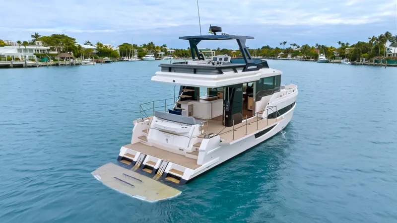 Slide: The Image of Luxury 2025 OKEAN 52 yacht cruising in serene blue waters. - 23